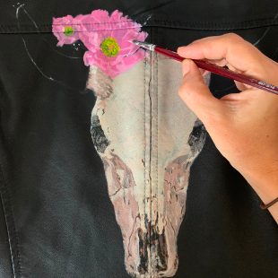 In progress shot of painting onto leather jacket.